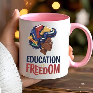 Mug with "Education is Freedom" text and profile of a Black woman with books in her hair.