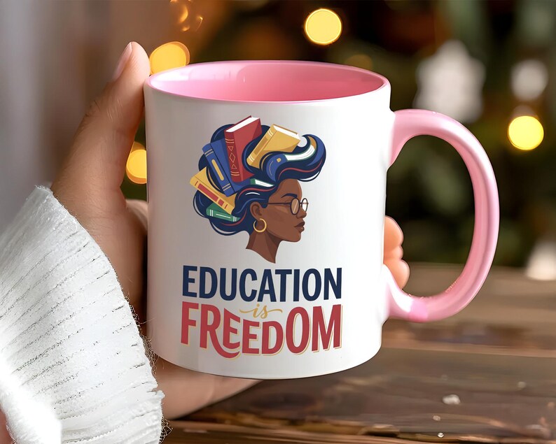 Mug with "Education is Freedom" text and profile of a Black woman with books in her hair.