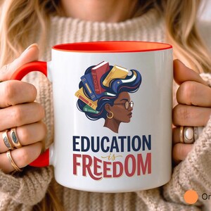 Red-handled mug with "Education is Freedom" and diverse woman design.