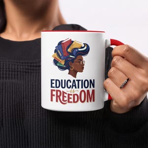 Mug with illustration of woman's head and "Education is Freedom" text.