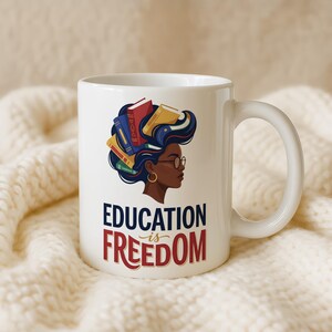 White mug with profile of Black woman with books in her hair, text reads "Education is Freedom".