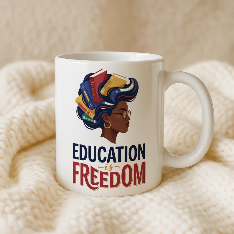 White mug with profile of Black woman with books in her hair, text reads "Education is Freedom".