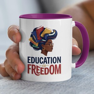 Mug with woman's profile and books forming hair, text reads "Education is Freedom".
