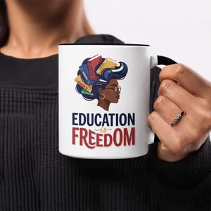 Mug with "Education is Freedom" text and woman with books in hair.