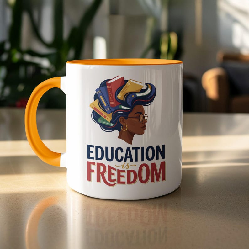 White mug with orange handle featuring a woman's profile with books for hair and "Education is Freedom" text.