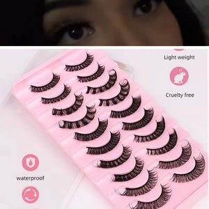May include: A collection of black false eyelashes presented on a pink tray. The image includes text that says "Light weight", "Cruelty free", "waterproof", and "reusable".