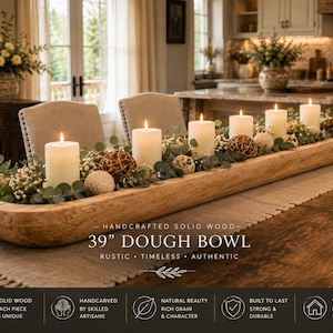May include: A long, hand-carved 39-inch solid wood dough bowl filled with white pillar candles, green eucalyptus leaves, small white flowers, and decorative woven spheres. The text on the image reads: HANDCRAFTED SOLID WOOD 39" DOUGH BOWL.
