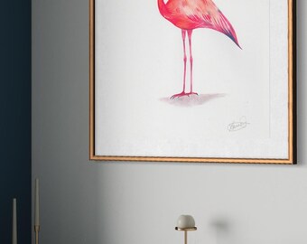 May include: A framed print featuring a watercolor illustration of a flamingo. The bird is depicted in shades of pink and red with a blue beak, set against a white background. The frame is gold-toned, and the artwork is displayed on a wall.