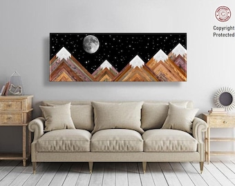 May include: A rectangular wall art piece depicting a mountain range under a starry night sky with a full moon. The mountains are made of wood in shades of brown, white, and purple. The artwork hangs above a beige sofa.