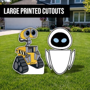 Peut inclure: Grands découpages imprimés des personnages WALL-E et EVE, debout sur de l'herbe verte. Le découpage WALL-E est jaune, gris et noir, avec le mot "WALL-E" imprimé dessus. Le découpage EVE est blanc avec une tête noire et des yeux bleus.