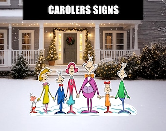 May include: Cartoon cutouts of carolers in a snowy yard. The figures are holding hands and wearing colorful outfits. The text "CAROLERS SIGNS" is at the top of the image. Christmas trees and a decorated front door are in the background.