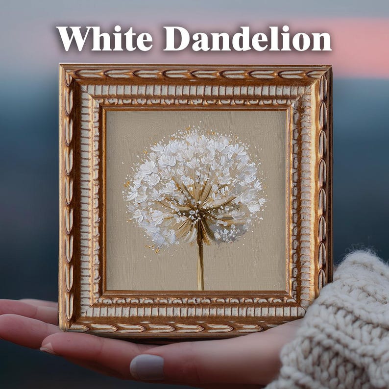 May include: A square framed painting titled White Dandelion featuring a textured white dandelion seed head against a solid beige background. The frame is ornate, metallic gold with a decorative carved pattern along the outer and inner edges.