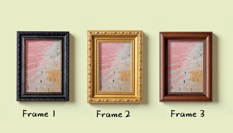May include: Three framed art prints. Each features a beach scene with figures. The frames are black, gold, and brown. The artwork has a pink and yellow sky with white waves. The text "Frame 1", "Frame 2", and "Frame 3" is below each frame.