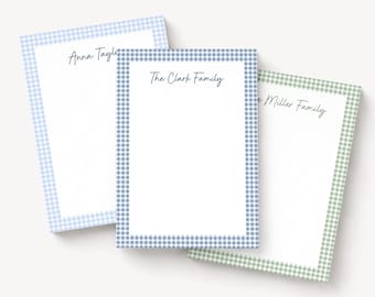 May include: Three rectangular stationery notepads with white centers and gingham borders in light blue, medium blue, and sage green. Each notepad features personalized black script text reading Anna Taylor, The Clark Family, and The Miller Family.