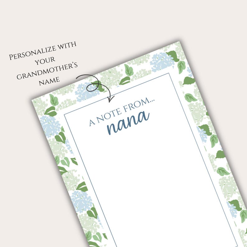 May include: A white notepad featuring a floral border of blue and green hydrangea flowers. The text "A note from... nana" is in a blue script font. The top left corner reads "Personalize with your grandmother's name."