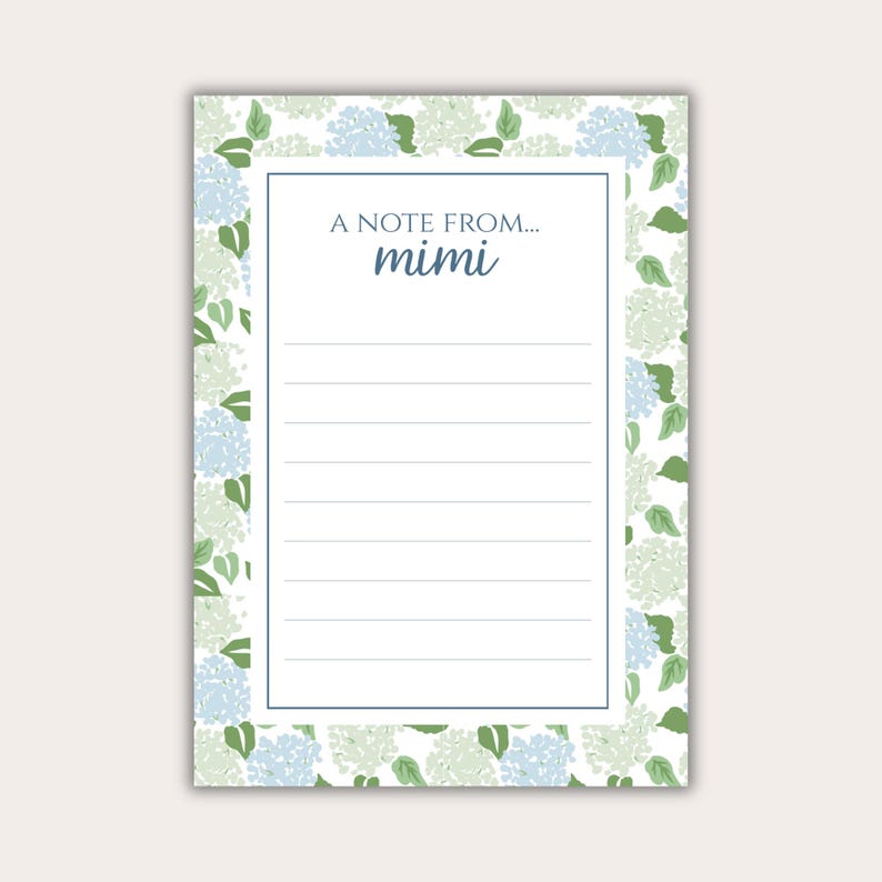 May include: A rectangular notepad featuring a floral design of blue and green hydrangeas on a white backdrop. The notepad has a white interior with lined pages and the text "A NOTE FROM... mimi" in blue.