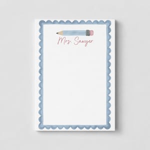May include: A rectangular notepad with a white center and a scalloped blue border. At the top, there is a horizontal illustration of a light blue pencil with a pink eraser. The text Mrs. Sawyer is printed in a pink script font below the pencil.