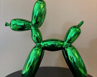 May include: A green balloon animal sculpture in the shape of a dog. The sculpture is made of a shiny, metallic material and has a reflective surface.