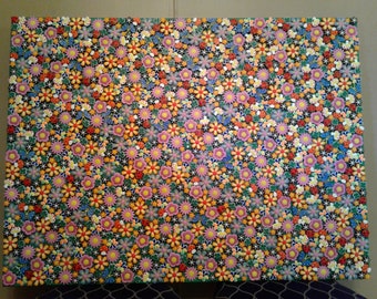May include: A close-up of a canvas painting depicting a field of colorful flowers. The flowers are painted in shades of pink, yellow, orange, red, and blue. The background is a dark green color.