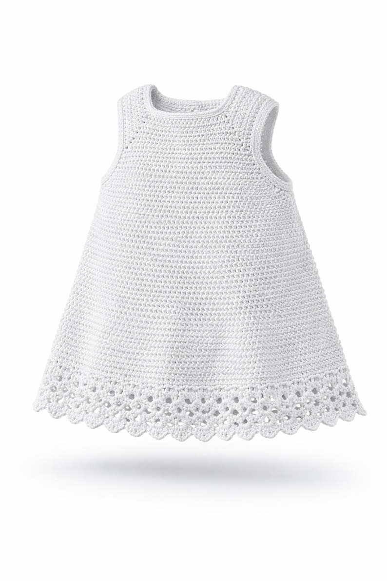May include: A sleeveless white dress crafted with a dense crochet stitch pattern throughout the bodice and skirt. The garment features a round neckline and a decorative, scalloped crochet lace border along the bottom hemline of the dress.
