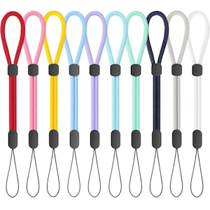 May include: A collection of nine wrist straps in various colors, including red, pink, yellow, blue, purple, teal, navy, gray, and white. Each strap features a loop for the wrist and a thin cord for attaching to a device.