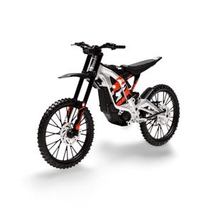 May include: A black and silver electric dirt bike with red accents. The bike has large, knobby tires, a black seat, and a front fender. The frame is silver with red and black graphics. The handlebars and suspension are black.