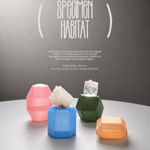May include: Four geometric, translucent, frosted, candy-colored stands for mineral specimens. The text reads: SPECIMEN HABITAT, Inspired by mineral geometries and the display habits of mineral collectors, this project reimagines the traditional specimen-stand as a more sculptural and spatial object. Collectible Series, Translucent Frosted Candy Edition.