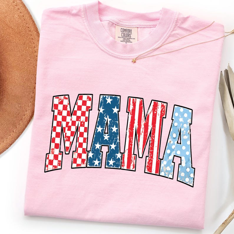 May include: A light pink Comfort Colors t-shirt with the word 