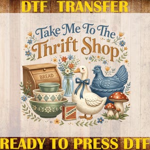 May include: DTF transfer design with the text "Take Me To The Thrift Shop." The design features a bread box, bowls, a duck with a blue bow, a blue chicken, mushrooms, and flowers. The words "Custom Print" and "Heat Transfer" are also visible.