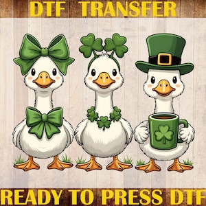 May include: DTF transfer featuring three cartoon geese with St. Patrick's Day themes. One goose wears a green bow, another a shamrock headband, and the third a green hat and holds a mug with a shamrock. The image includes the text "DTF TRANSFER" and "READY TO PRESS DTF".