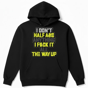 May include: Black hooded sweatshirt with the text "I DON'T HALF A#S ANYTHING I F#CK IT ALL THE WAY UP" in white, yellow, and gray. The hoodie has a front pocket and a drawstring hood.