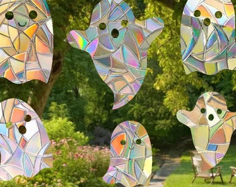May include: Six iridescent stained glass ghost window clings. Each ghost has a different design and is made of colorful, translucent glass. The ghosts are perfect for decorating windows for Halloween.
