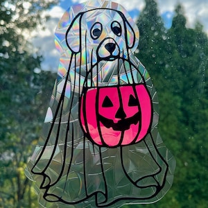 May include: A white dog wearing a ghost costume and carrying a pink pumpkin with a jack-o'-lantern face. The dog is on a clear background with a holographic effect.