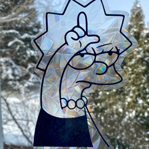May include: A black and white sticker of a cartoon character with yellow hair giving the middle finger. The sticker is on a clear background with a rainbow iridescent effect.