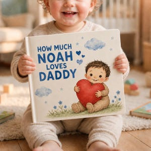 May include: A children's book titled "HOW MUCH NOAH LOVES DADDY" held by a smiling child. The cover features a cartoon illustration of a baby holding a red heart, with blue hearts, clouds, and flowers. The book is a personalized gift.