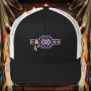 May include: Black and white trucker hat with a colorful embroidered design. The design features a geometric pattern in red, blue, and white, with a feather accent. The hat has a curved brim and a mesh back.