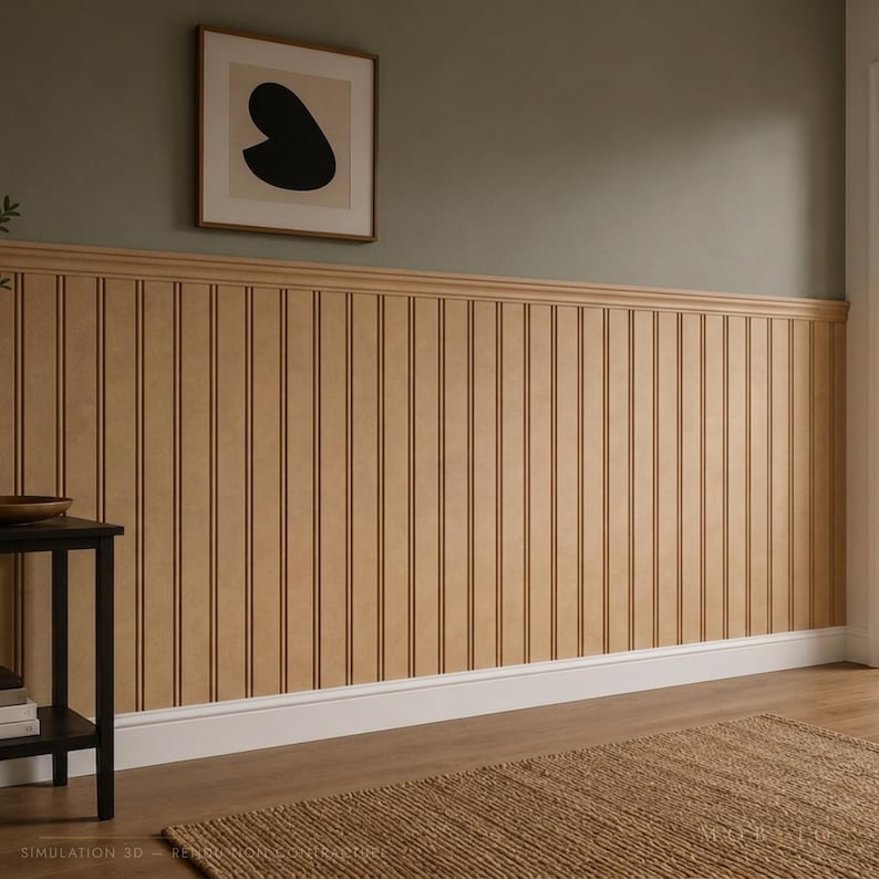 May include: A wall featuring light brown vertical beadboard paneling with a matching chair rail molding. The upper wall is painted a muted sage green, and a framed square art piece with a black abstract shape hangs on the wall above the paneling.