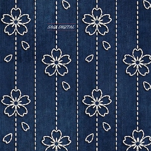 May include: A dark blue denim fabric featuring a repeating pattern of white stitched cherry blossom flowers and vertical dashed lines. The text SAGI DIGITAL is printed in a small red box near the top center of the textile design.