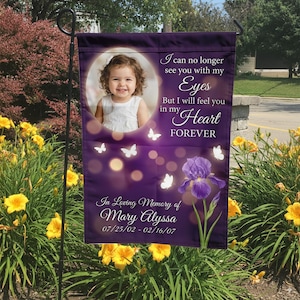 May include: Purple garden flag with a photo of a child, butterflies, and an iris flower. Text reads "I can no longer see you with my Eyes, But I will feel you in my Heart FOREVER. In Loving Memory of Mary Alyssa 07/25/02 - 02/16/07."