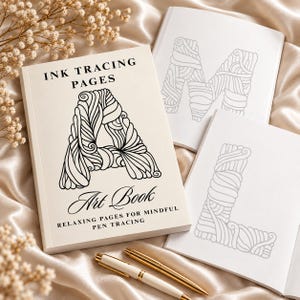 May include: A collection of ink tracing art books featuring a cream-colored cover with the text INK TRACING PAGES ART BOOK RELAXING PAGES FOR MINDFUL PEN TRACING and a large letter A, alongside two gold pens and open pages showing letters M and L.