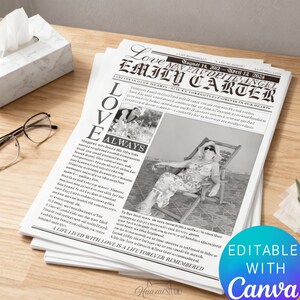 May include: A stack of memorial newspaper prints with the headline "Love, Emily Carter." The black and white prints feature a photo of a person in a chair, with text that reads "A life lived with love is a life forever remembered." The prints are on a wooden surface.