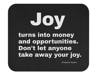 May include: A black square coaster with rounded corners. The word "Joy" is in large white letters at the top. Below, white text reads "turns into money and opportunities. Don't let anyone take away your joy."