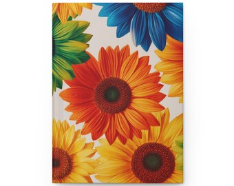 May include: A rectangular notebook featuring a vibrant, multi-colored floral pattern of sunflowers on a light background. The cover displays large, detailed sunflower illustrations in shades of orange, yellow, green, and blue, with dark centers.