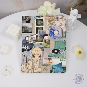 May include: A decorative art piece with a collage of images, including a cassette tape, a CD, a record player, and cartoon figures. The color palette includes beige, blue, and green. The word "Tokyo" is visible on the piece.