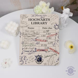May include: A beige-colored Hogwarts Library notebook with handwritten notes and signatures. The notebook features the text "Hogwarts Library" at the top, with a list of names and due dates. The word "OVERDUE" is stamped on the dates.