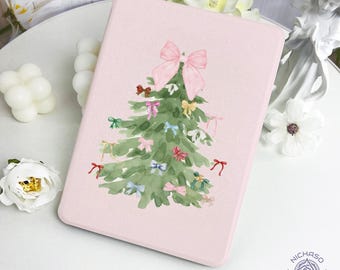 May include: A light pink rectangular case featuring a watercolor Christmas tree design. The tree is green with colorful bows and a large pink bow at the top. The case has rounded corners and a soft, matte finish.