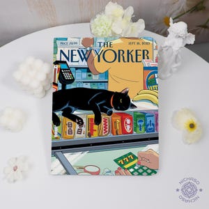 May include: A notebook with a New Yorker cover illustration. The artwork shows a black cat on a shop shelf, with the text "THE NEW YORKER" and the date "SEPT. 18, 2023". The price is £8.99.