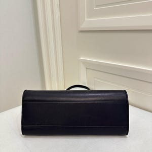 triangular leather bag
sculpted leather handbag
architectural shape purse
geometric leather clutch
curved silhouette handbag
structured base purse
minimal shape handbag
modern sculptural bag
boxy leather shoulder bag
underarm baguette bag
90s shoulder bag leather
clean structured purse
contemporary clutch handbag
statement minimalist purse
compact structured handbag