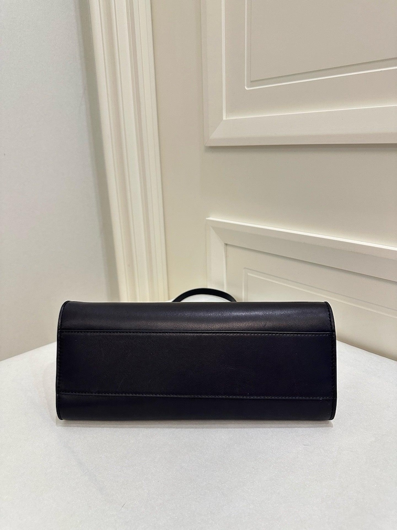 triangular leather bag
sculpted leather handbag
architectural shape purse
geometric leather clutch
curved silhouette handbag
structured base purse
minimal shape handbag
modern sculptural bag
boxy leather shoulder bag
underarm baguette bag
90s shoulder bag leather
clean structured purse
contemporary clutch handbag
statement minimalist purse
compact structured handbag