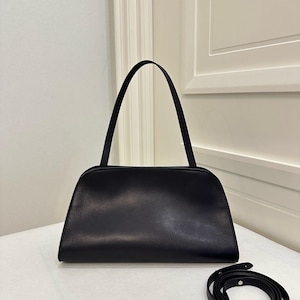 genuine leather handbag
smooth leather purse
soft structured leather
premium leather clutch
handmade leather bag
real leather shoulder bag
high quality leather purse
durable leather handbag
zipper closure handbag
detachable strap purse